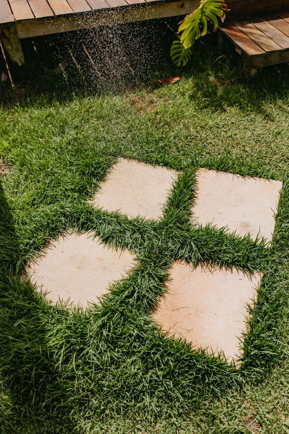 Square limestone stepping stones set into new sod