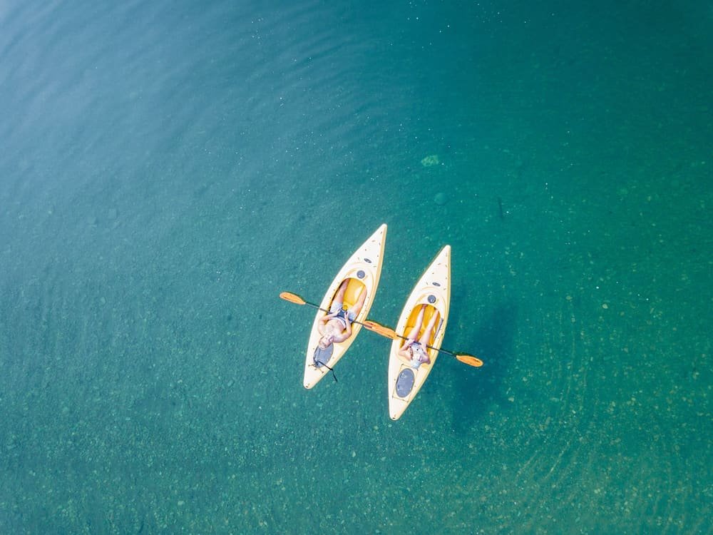 Two kayaks on clear water, seen from above